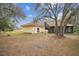 Backyard view of the property featuring a screened-in porch and lush greenery at 702 Centerbrook Dr, Brandon, FL 33511