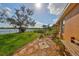 Secluded backyard featuring a lush lawn with mature trees and beautiful lakeside views at 715 Parker Den Dr, Ruskin, FL 33570