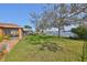 Expansive backyard with lush lawn and lake view, complemented by mature trees and established landscaping at 715 Parker Den Dr, Ruskin, FL 33570
