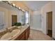 Bathroom featuring dual sinks, granite countertops, and a step-in shower with white subway tile surround at 715 Parker Den Dr, Ruskin, FL 33570
