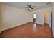 Spacious bedroom features wood floors, a ceiling fan, and a door leading to an en-suite bathroom at 715 Parker Den Dr, Ruskin, FL 33570