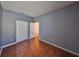 Bedroom with hardwood floors, two closets, and neutral paint at 715 Parker Den Dr, Ruskin, FL 33570