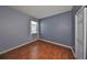 Bedroom with wood floors, a window with blinds and drapes, and a closet for storage at 715 Parker Den Dr, Ruskin, FL 33570
