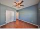 Bedroom with wood floors and a closet provides a cozy and practical living space at 715 Parker Den Dr, Ruskin, FL 33570