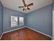 Bedroom with hardwood floors, ceiling fan and natural light from two windows at 715 Parker Den Dr, Ruskin, FL 33570