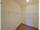 Walk-in closet offers ample storage space with shelving on the walls and wood-style flooring at 715 Parker Den Dr, Ruskin, FL 33570