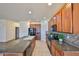Modern kitchen featuring granite countertops, wood cabinets, and black appliances at 715 Parker Den Dr, Ruskin, FL 33570