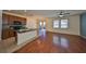 Open kitchen with granite counters and stainless appliances flows into the living space at 715 Parker Den Dr, Ruskin, FL 33570