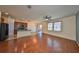 Open-concept living area with hardwood floors, ceiling fan and access to the kitchen at 715 Parker Den Dr, Ruskin, FL 33570