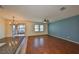 Open-concept living area with hardwood floors, ceiling fan and access to the kitchen at 715 Parker Den Dr, Ruskin, FL 33570