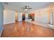 Spacious living room flows into the kitchen, featuring hardwood floors and a ceiling fan at 715 Parker Den Dr, Ruskin, FL 33570