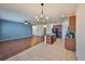 Open-concept living area with hardwood floors, ceiling fan and access to the kitchen at 715 Parker Den Dr, Ruskin, FL 33570