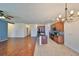 Open-concept living space featuring tile and wood floors, connecting the kitchen and living room at 715 Parker Den Dr, Ruskin, FL 33570