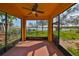 A screened-in porch provides a delightful view of the lush backyard and glistening lake at 715 Parker Den Dr, Ruskin, FL 33570