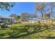 Wide shot of the backyard featuring a well-manicured lawn and a wooden deck at 8555 81St Way, Largo, FL 33777