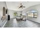 Living room shows a large arched window, tile flooring, neutral paint colors, and comfortable seating at 8555 81St Way, Largo, FL 33777