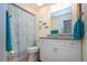 Bright bathroom with nautical decor, granite countertop, and seashell themed shower curtain at 2016 E View Dr, Sun City Center, FL 33573