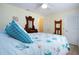 Bright bedroom with a vintage dresser, mirror, and a bed with nautical themed bedding at 2016 E View Dr, Sun City Center, FL 33573