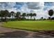 Beautiful golf course view with lush green fairways and mature trees under a cloudy sky at 2016 E View Dr, Sun City Center, FL 33573