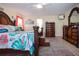 Bright main bedroom with tropical decor, wood floors and dark wood furniture at 2016 E View Dr, Sun City Center, FL 33573