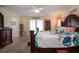 Bright main bedroom with tropical decor, wood floors and dark wood furniture at 2016 E View Dr, Sun City Center, FL 33573