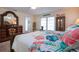 Bright main bedroom with tropical decor, wood floors and dark wood furniture at 2016 E View Dr, Sun City Center, FL 33573