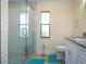 Bathroom featuring walk in shower with glass door, subway tile, niche, and handheld sprayer at 2016 E View Dr, Sun City Center, FL 33573