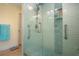 Shower with glass door, grab bars, niche, subway tile, handheld sprayer, and wood look floor at 2016 E View Dr, Sun City Center, FL 33573