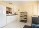 Bright sunroom with white cabinets, a view to the kitchen, and tile floors at 2016 E View Dr, Sun City Center, FL 33573