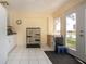 Bright sunroom with white cabinets, a view to the backyard, and tile floors at 2016 E View Dr, Sun City Center, FL 33573