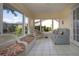 Inviting sunroom with tile flooring, white wicker furniture, and plenty of natural light at 2016 E View Dr, Sun City Center, FL 33573