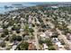 Expansive aerial view of a residential area near water, showcasing streets lined with trees at 2391 66Th S Ter, St Petersburg, FL 33712