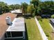 Aerial view of a large, grassy backyard with a white fence and mature trees; a pool is visible in the background at 2391 66Th S Ter, St Petersburg, FL 33712