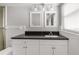 Elegant bathroom vanity with a dark countertop, white cabinets, and two framed mirrors, providing ample storage at 2391 66Th S Ter, St Petersburg, FL 33712