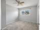 Bedroom with neutral walls, light carpet, window, and ceiling fan at 2391 66Th S Ter, St Petersburg, FL 33712