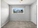 Neutral bedroom features a large window offering views of the surrounding neighborhood at 2391 66Th S Ter, St Petersburg, FL 33712