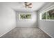 Bright bedroom featuring neutral walls, carpet, and a ceiling fan at 2391 66Th S Ter, St Petersburg, FL 33712