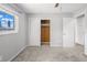 Bedroom with neutral walls, light carpet, window, and closet with sliding doors at 2391 66Th S Ter, St Petersburg, FL 33712