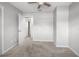 Bedroom with neutral walls, light carpet, ceiling fan, and an open closet at 2391 66Th S Ter, St Petersburg, FL 33712