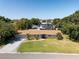 Charming single-story home with well-maintained lawn, palm trees, and a driveway leading to a garage at 2391 66Th S Ter, St Petersburg, FL 33712