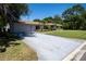 Single-story home boasting an attached garage and mature trees surrounding the property at 2391 66Th S Ter, St Petersburg, FL 33712