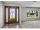 Inviting foyer with a decorative glass front door and large window providing ample natural light at 2391 66Th S Ter, St Petersburg, FL 33712