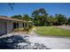 Home exterior view showcasing a lush lawn, palm trees and a curved walkway at 2391 66Th S Ter, St Petersburg, FL 33712