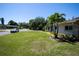 Exterior view of the home showcasing a lush lawn and curb appeal at 2391 66Th S Ter, St Petersburg, FL 33712