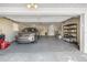 Spacious garage featuring a parked SUV, storage shelving, and ample room for parking and storage at 2391 66Th S Ter, St Petersburg, FL 33712