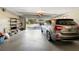 Open garage showcasing a silver SUV parked inside with shelving and a view of the neighborhood at 2391 66Th S Ter, St Petersburg, FL 33712