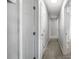 Hallway with multiple doors, light walls, and carpeted floor at 2391 66Th S Ter, St Petersburg, FL 33712