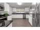 Well-lit kitchen featuring stainless steel appliances and abundant counter space at 2391 66Th S Ter, St Petersburg, FL 33712