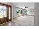 Spacious living room features dark wood front door, large window, ceiling fan, and neutral paint at 2391 66Th S Ter, St Petersburg, FL 33712