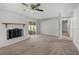 Bright living room with a white brick fireplace and sliding glass doors to a screened-in porch at 2391 66Th S Ter, St Petersburg, FL 33712